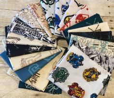 a pile of harry potter handkerchiefs sitting on top of a wooden table next to each other