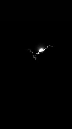 the moon is shining brightly in the dark night sky with some clouds and lightening