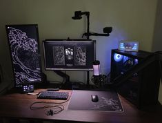 a desk with a computer, keyboard and mouse on it in front of a monitor