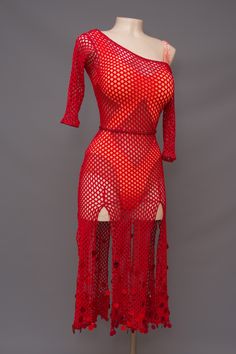 a mannequin is wearing a red dress with long sleeves and an open back