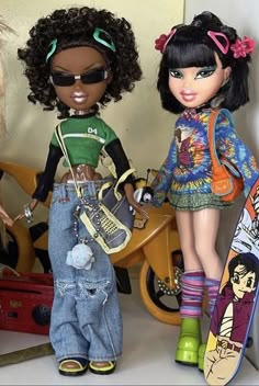 two dolls standing next to each other with skateboards on their feet and one holding a bag