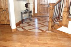 an entry way with wooden stairs and tile flooring