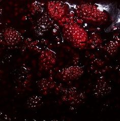 raspberries are being cooked in a pot with water