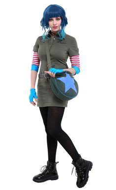 a woman with blue hair is holding a green bag and wearing black tights while standing in front of a white background