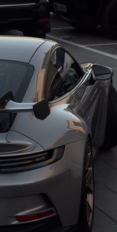 a silver sports car is parked on the street