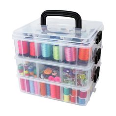 a plastic box filled with lots of spools of thread