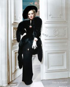 an old fashion photo of a woman in a fur coat and hat