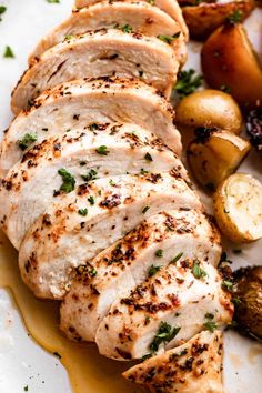 sliced chicken and potatoes on a white plate