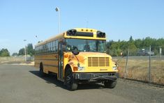 a yellow school bus driving down the road