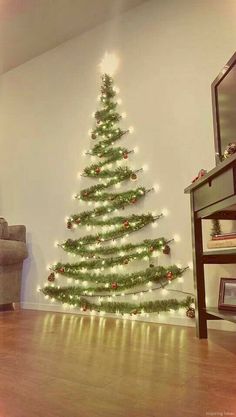 a living room with a christmas tree on the wall