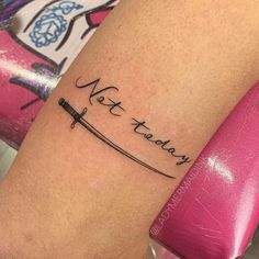 a woman's arm with a tattoo that reads, not today and an arrow