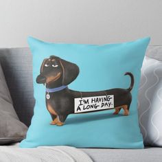 a dachshund dog holding a sign that says i'm having a long day