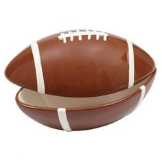 a brown and white bowl with a football on the side, isolated against a white background