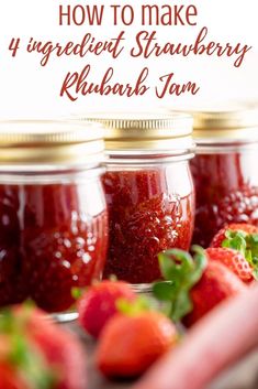 three jars filled with strawberry jam on top of a table