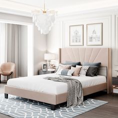 a bedroom with a bed, nightstands and pictures on the wall above it in neutral colors