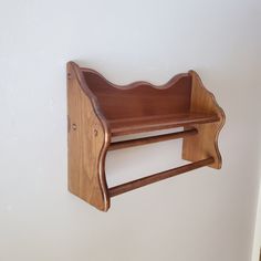 a wooden shelf mounted to the side of a wall