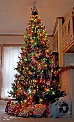 a brightly lit christmas tree with presents under it