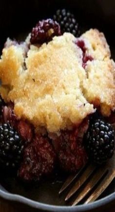 a close up of a plate of food with berries and crumbs on it