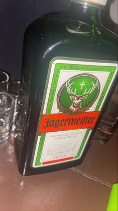 a bottle of jagermeister next to two glasses