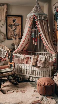 a baby's room with a canopy bed, chair and rugs on the floor