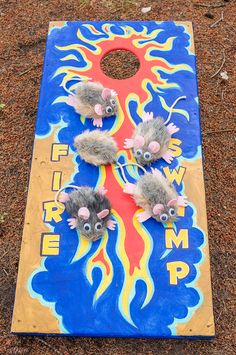 two mice on a cornhole game with flames