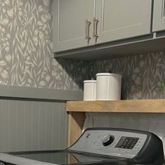 a washer and dryer sitting in a kitchen next to cabinets with cupboards