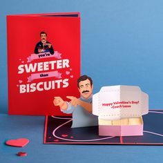 a paper cut out of a man holding a box and pointing to it with the words sweeter than biscuits on it