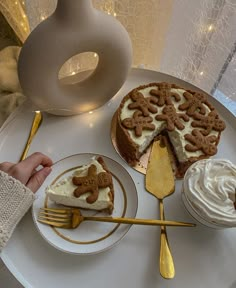 a white plate topped with two slices of cake next to cupcakes and a fork