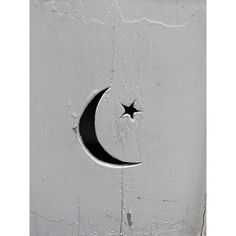 a crescent and star on a white painted wall