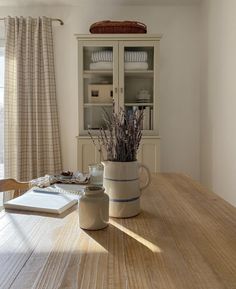 a wooden table topped with a vase filled with flowers