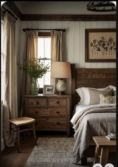 a bed room with a neatly made bed and a night stand next to a window