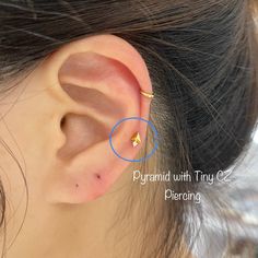 a woman's ear is shown with a tiny blue circle around it