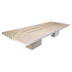 a wooden bench sitting on top of a white wall