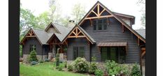 a large house with lots of windows and wood trimmings on the side of it