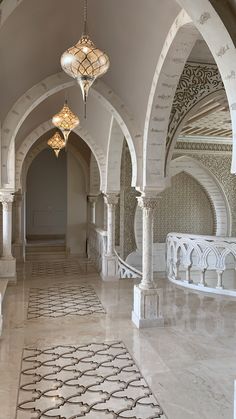 an ornately decorated hallway with chandeliers and marble flooring