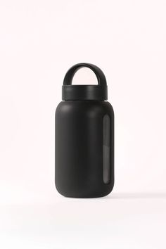 a black bottle with a handle is shown on a white background and there is no image to describe