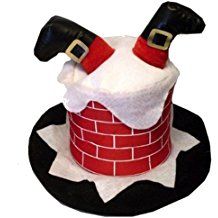 a black and white hat on top of a red brick chimney with santa claus's cape