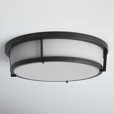 a round light fixture hanging from the ceiling