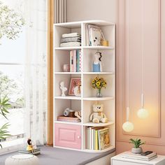 a white book shelf sitting next to a window filled with toys and books on top of it