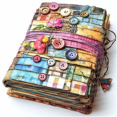 an altered book with buttons and flowers on it