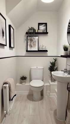 a white toilet sitting in a bathroom next to a sink and a radiator