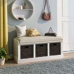 a white bench sitting next to a wall with two baskets on it's sides