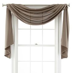 an open window with curtains hanging over it