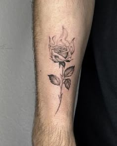 a man's arm with a rose tattoo on it