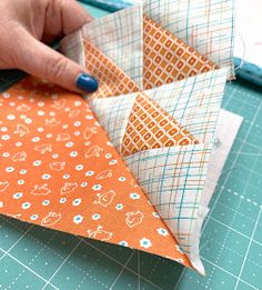 someone is making an origami star out of fabric