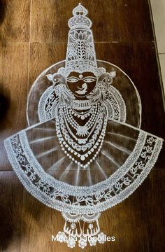 an intricately designed glass plate on a wooden floor