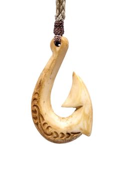 a pendant with an animal's head hanging from a rope