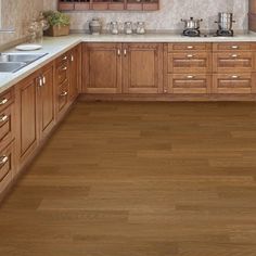 a kitchen filled with lots of wooden cabinets and counter top space next to a window