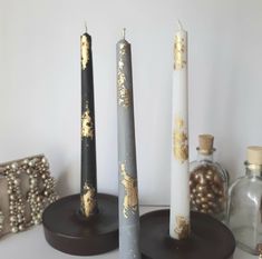 three candles sitting on top of a table