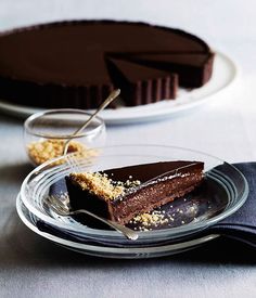 there is a piece of chocolate cake on the plate next to another slice of pie